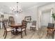 Cozy dining room with hardwood flooring, a stylish chandelier, and easy access to kitchen and entrance at 2342 Clemblue Rd, Clermont, FL 34715