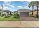 Charming one story home featuring a paved driveway, two-car garage, and beautifully landscaped front yard at 2342 Clemblue Rd, Clermont, FL 34715