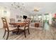 Open-concept living space boasts hardwood floors, a cozy sectional, and natural lighting at 2342 Clemblue Rd, Clermont, FL 34715