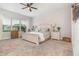Spacious main bedroom with plush carpet, a large window, and neutral decor at 2342 Clemblue Rd, Clermont, FL 34715