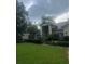 Charming single-story home featuring a well-manicured lawn and lush landscaping at 2435 Sweetwater Country Club Place Dr, Apopka, FL 32712