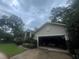 Attached two-car garage exhibiting ample storage space with driveway and partial front yard at 2435 Sweetwater Country Club Place Dr, Apopka, FL 32712