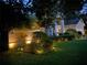 Charming home with well-lit landscaping, lush green lawn and manicured shrubbery at 2435 Sweetwater Country Club Place Dr, Apopka, FL 32712