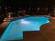 Sparkling pool illuminated at night with a screened lanai at 2435 Sweetwater Country Club Place Dr, Apopka, FL 32712
