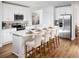Modern kitchen featuring white cabinets, stainless steel appliances, a large island, and hardwood floors at 2782 Virginia Pine Dr, Bartow, FL 33830