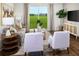 Stylish living room with hardwood floors, neutral decor, and a large window showcasing a beautiful backyard at 2782 Virginia Pine Dr, Bartow, FL 33830