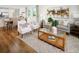Inviting open-concept living room with hardwood floors, modern decor, and seamlessly connected to the dining area at 2782 Virginia Pine Dr, Bartow, FL 33830