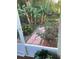 Backyard with banana trees, red roses, and a brick pathway at 2808 Manatee Rd, Tavares, FL 32778