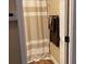 Clean bathroom with shower featuring neutral-toned shower curtain and towel rack at 2808 Manatee Rd, Tavares, FL 32778