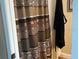 Shower with bronze patterned curtain and a black robe hanging behind it at 2808 Manatee Rd, Tavares, FL 32778