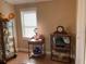 Bedroom featuring a curio cabinet, side table, clock, and a bright window for natural light at 2808 Manatee Rd, Tavares, FL 32778