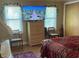 Bedroom featuring a television above a chest-of-drawers with a window view and two chairs at 2808 Manatee Rd, Tavares, FL 32778