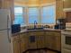 Kitchen with wooden cabinets, modern appliances, and a double-basin sink at 2808 Manatee Rd, Tavares, FL 32778