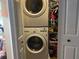 Efficient laundry space featuring stacked washer and dryer units with shelving at 2808 Manatee Rd, Tavares, FL 32778