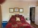 Cozy main bedroom featuring stylish decor, including framed artwork and coordinated bedding at 2808 Manatee Rd, Tavares, FL 32778