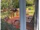 Patio with red roses, a grill, and lounge chairs at 2808 Manatee Rd, Tavares, FL 32778