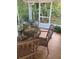 Relaxing patio space featuring wicker furniture and views of the serene backyard, creating a peaceful retreat at 2808 Manatee Rd, Tavares, FL 32778