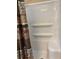 White shower with built-in shelves and bronze patterned shower curtain at 2808 Manatee Rd, Tavares, FL 32778