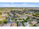 Expansive aerial view of the community, showcasing a picturesque lake surrounded by beautiful homes and lush greenery at 2830 Alton Dr, Kissimmee, FL 34741