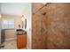 Full bathroom showcasing a shower and double vanity with granite counters at 2830 Alton Dr, Kissimmee, FL 34741