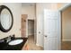 Bright bathroom with a tiled shower, walk-in closet, and vanity with granite counters at 2830 Alton Dr, Kissimmee, FL 34741
