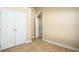 A light-filled bedroom with neutral walls and double closet at 2830 Alton Dr, Kissimmee, FL 34741
