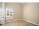Neutral bedroom featuring tile flooring, white trim, and window with plantation shutters at 2830 Alton Dr, Kissimmee, FL 34741