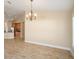 Bright dining area with decorative chandelier and tile floors next to kitchen at 2830 Alton Dr, Kissimmee, FL 34741