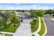 Charming single-Gathering home showcasing a well-manicured lawn, a wide driveway, and lush landscaping at 2830 Alton Dr, Kissimmee, FL 34741