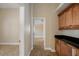 Hallway showcasing beautiful cabinetry, neutral paint, and tile flooring at 2830 Alton Dr, Kissimmee, FL 34741