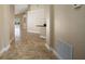 Neutral hallway featuring tile flooring connecting the home's living spaces at 2830 Alton Dr, Kissimmee, FL 34741