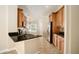 Kitchen with stainless appliances, dark counters and wood cabinets, open to breakfast nook at 2830 Alton Dr, Kissimmee, FL 34741