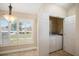 Laundry room featuring a washer and dryer behind a door and window with plantation shutters at 2830 Alton Dr, Kissimmee, FL 34741