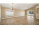 Spacious living room with tile flooring, vaulted ceilings and sliding door access to the lanai at 2830 Alton Dr, Kissimmee, FL 34741