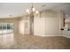 Open-concept living room with tile floor, chandelier and access to patio at 2830 Alton Dr, Kissimmee, FL 34741