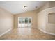 Bright, tile-floored living room with sliding door access to the screened-in patio at 2830 Alton Dr, Kissimmee, FL 34741