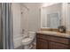 A tidy bathroom showcasing a shower-tub combo, a vanity with a sink, and neutral color tones for a calming space at 3223 Blazing Star Ln, Harmony, FL 34773