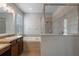 Well-lit bathroom with a soaking tub, separate shower, and double vanity sinks at 3223 Blazing Star Ln, Harmony, FL 34773