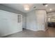 A stylish bedroom features a sleek pull-down bed with built-in shelving, complemented by neutral walls and tile flooring at 3223 Blazing Star Ln, Harmony, FL 34773