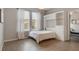A cozy bedroom showcases a pull-down bed with built-in shelving and bright natural light from the large window at 3223 Blazing Star Ln, Harmony, FL 34773