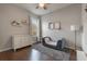 A calming bedroom with soft gray walls, wooden floors, plush rug, dresser, and matching decor for cozy comfort at 3223 Blazing Star Ln, Harmony, FL 34773