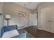 A cozy bedroom features hardwood floors, neutral walls, and a stylish daybed with coordinated decor for a relaxing retreat at 3223 Blazing Star Ln, Harmony, FL 34773