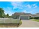Charming home with a 2-car garage, manicured lawn, and a classic white picket fence at 3223 Blazing Star Ln, Harmony, FL 34773