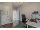 A bright home office featuring hardwood floors, a modern desk setup, and ample storage, perfect for productivity at 3223 Blazing Star Ln, Harmony, FL 34773
