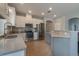 Bright kitchen boasting stainless steel appliances, white cabinets, gray accent island, and ample counter space at 3223 Blazing Star Ln, Harmony, FL 34773