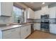 Well-lit kitchen featuring stainless steel appliances, granite counters, undermount sink, and ample cabinet space at 3223 Blazing Star Ln, Harmony, FL 34773