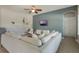 Spacious living room with a large sofa, ceiling fan, and stylish decor elements at 3223 Blazing Star Ln, Harmony, FL 34773