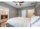 Large main bedroom with ensuite bathroom, ceiling fan, and hardwood floors at 3223 Blazing Star Ln, Harmony, FL 34773