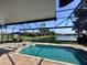 Inviting screened-in pool and jacuzzi with scenic lake views, perfect for outdoor relaxation and entertainment at 3225 Regal Crest Dr, Longwood, FL 32779