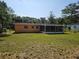 View of the home's screened porch and backyard with chain-link fence at 3516 Ridgemont Rd, Orlando, FL 32808